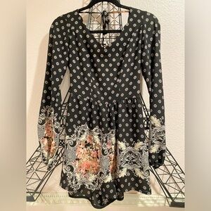 Black long sleeve romper with white and pink print